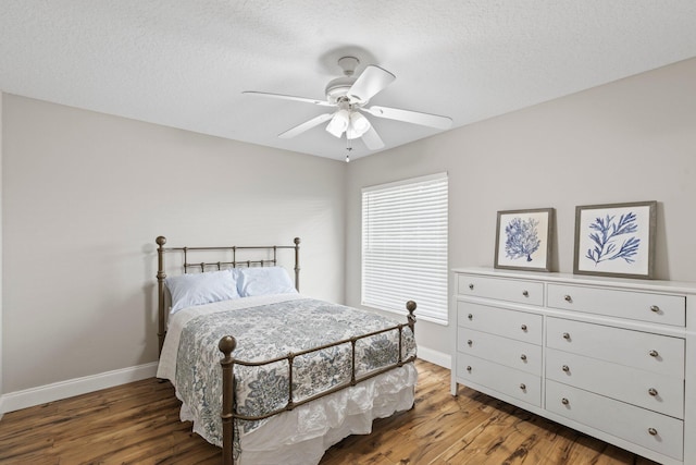 bedroom featuring ceiling fan, hardwood / wood-style floors, and a textured ceiling