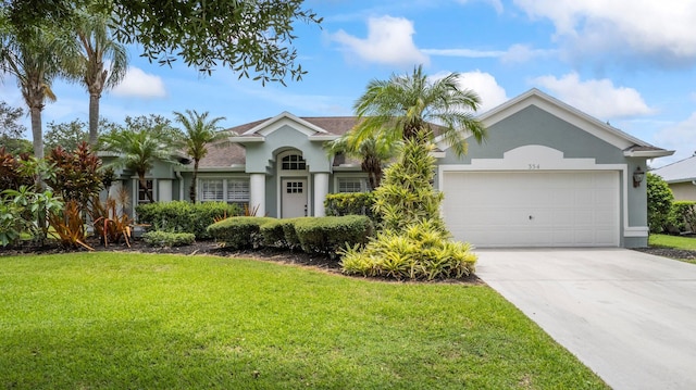 ranch-style home with a garage and a front lawn