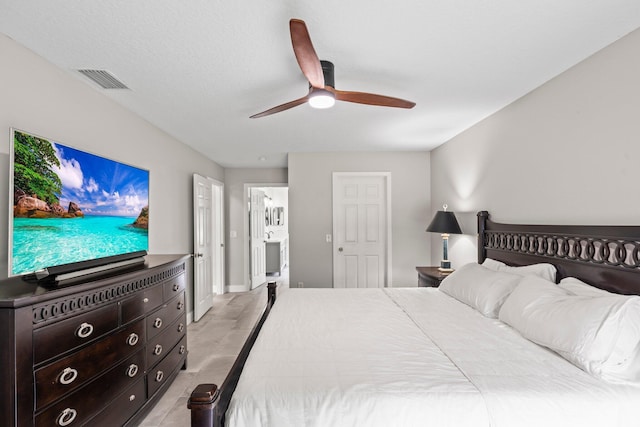 bedroom with ceiling fan and connected bathroom