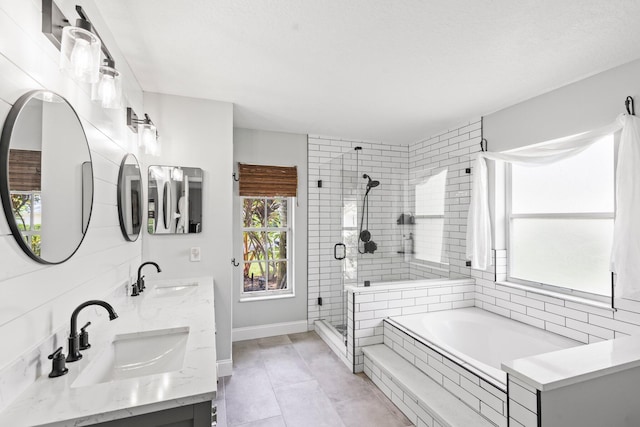 bathroom with tile patterned flooring, vanity, and plus walk in shower