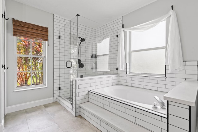 bathroom with tile patterned flooring and shower with separate bathtub