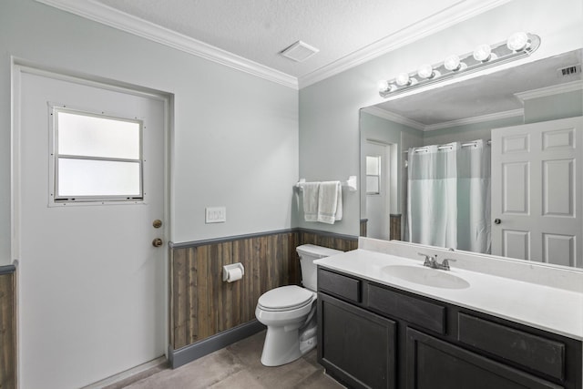 bathroom with wooden walls, vanity, a textured ceiling, and ornamental molding