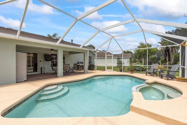 view of pool with a patio area, ceiling fan, and glass enclosure