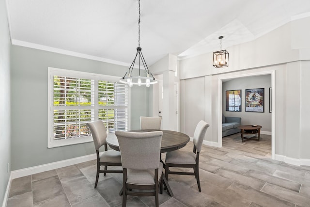 dining room with a chandelier, lofted ceiling, and ornamental molding