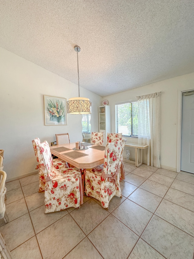 unfurnished dining area with tile patterned floors, lofted ceiling, and a textured ceiling