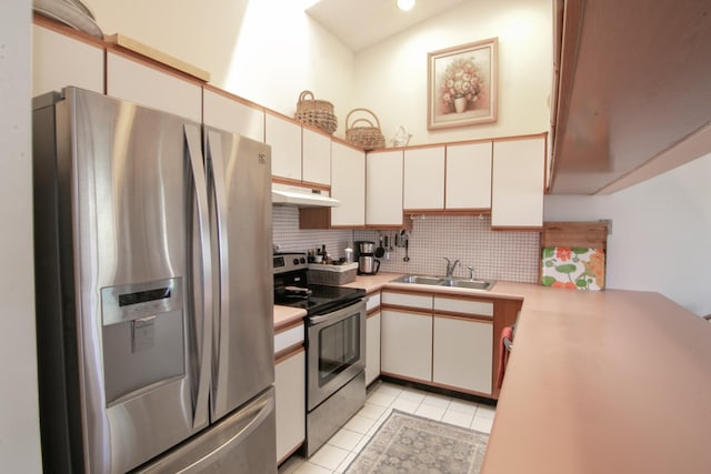 kitchen with white cabinets, light tile patterned flooring, sink, and appliances with stainless steel finishes