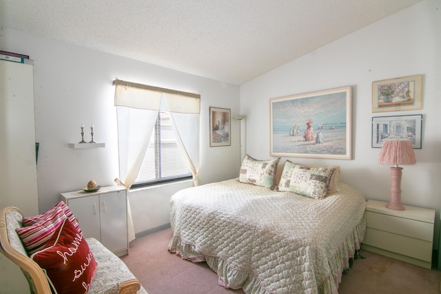 carpeted bedroom with a textured ceiling and vaulted ceiling