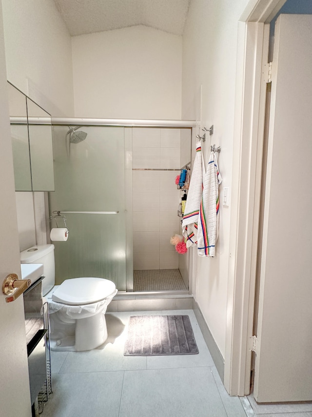 bathroom featuring an enclosed shower, toilet, and a textured ceiling