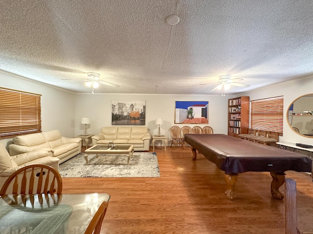 game room with hardwood / wood-style floors, a textured ceiling, and billiards