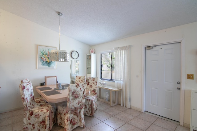 tiled dining area featuring a textured ceiling