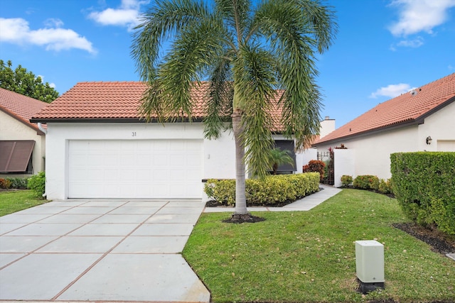 mediterranean / spanish home featuring a front lawn and a garage