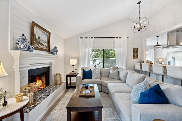 living room featuring an inviting chandelier, vaulted ceiling, and hardwood / wood-style flooring