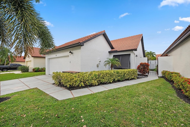 view of side of home with a garage and a yard