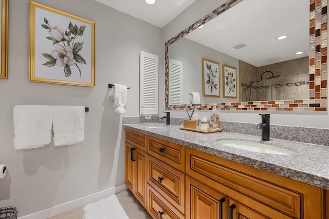 bathroom featuring vanity and tiled shower