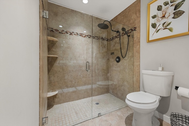 bathroom with tile patterned flooring, toilet, and walk in shower