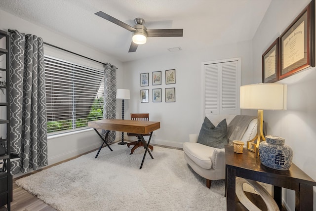 office with ceiling fan, hardwood / wood-style floors, and a textured ceiling