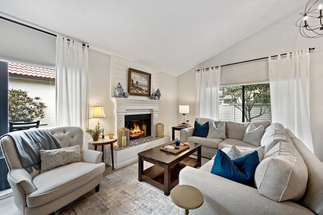 living room with hardwood / wood-style floors, lofted ceiling, and a notable chandelier