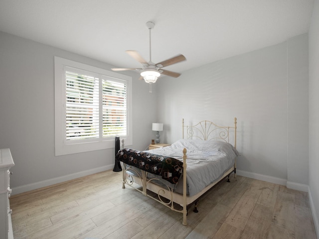 bedroom with ceiling fan and light wood-type flooring