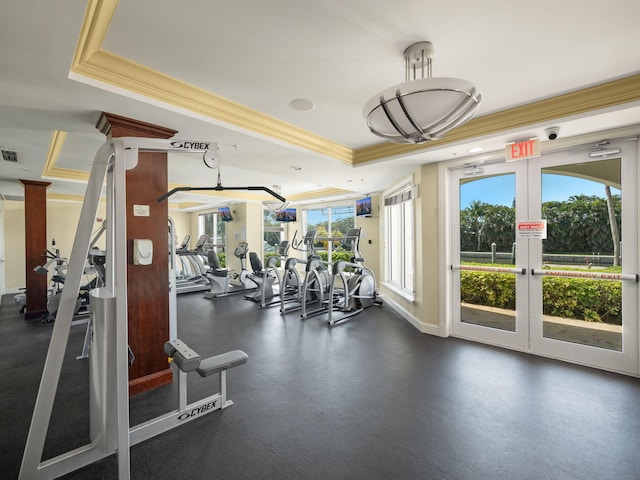 gym featuring a tray ceiling, crown molding, and french doors