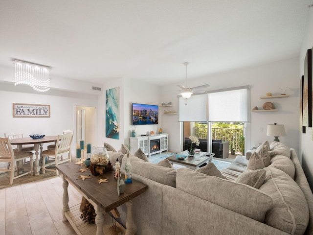 living room featuring light hardwood / wood-style floors and ceiling fan