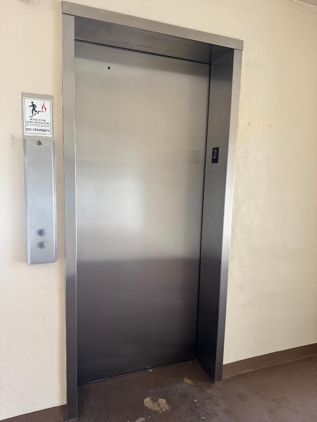 room details featuring concrete flooring and elevator