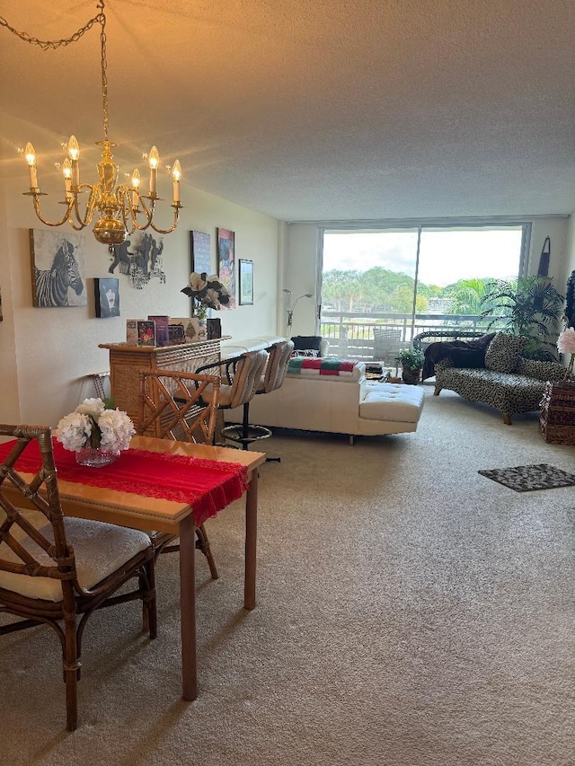 carpeted dining room featuring plenty of natural light, a textured ceiling, and an inviting chandelier