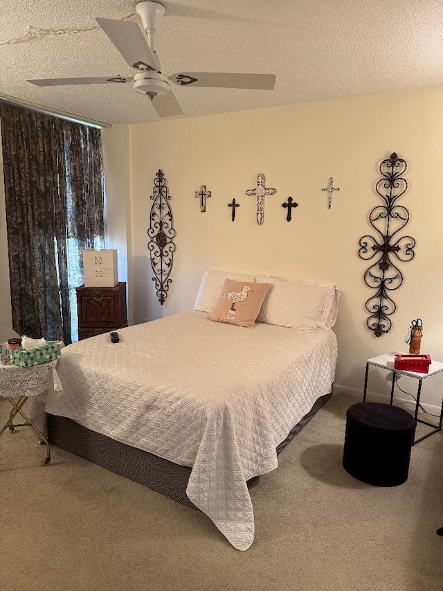 carpeted bedroom with a textured ceiling and ceiling fan