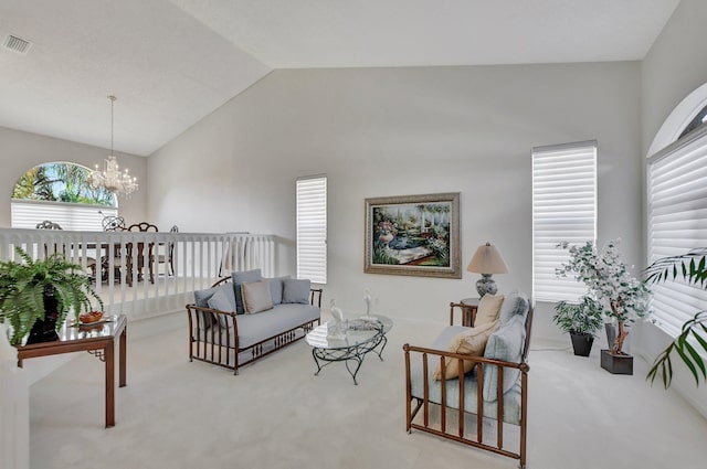 living room featuring a chandelier, carpet, and lofted ceiling