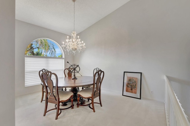 dining room featuring light carpet, a chandelier, and vaulted ceiling