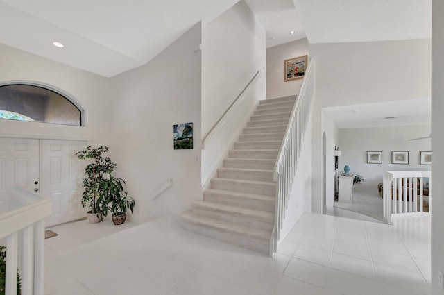 entrance foyer featuring light tile patterned floors and a high ceiling