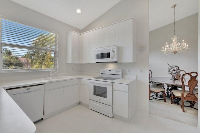 kitchen featuring white cabinets, white appliances, a chandelier, and sink