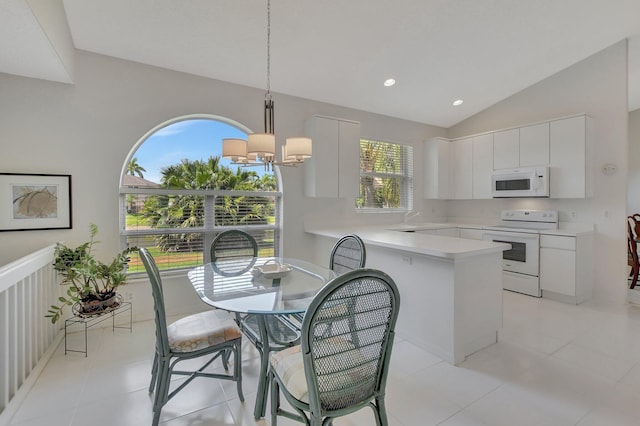 kitchen with white cabinetry, an inviting chandelier, pendant lighting, vaulted ceiling, and white appliances