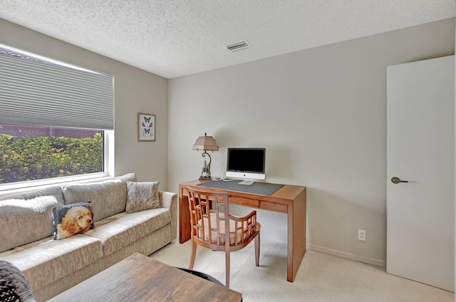 office area with light colored carpet and a textured ceiling