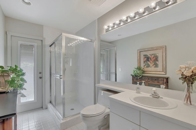 bathroom featuring toilet, vanity, tile patterned floors, and an enclosed shower