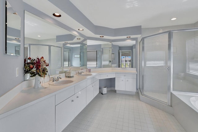 bathroom featuring tile patterned floors, vanity, and shower with separate bathtub