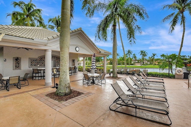 view of patio / terrace featuring a water view and ceiling fan