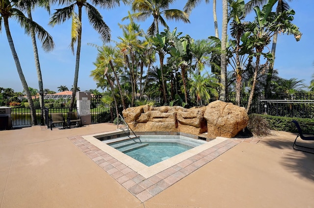 view of swimming pool featuring a community hot tub