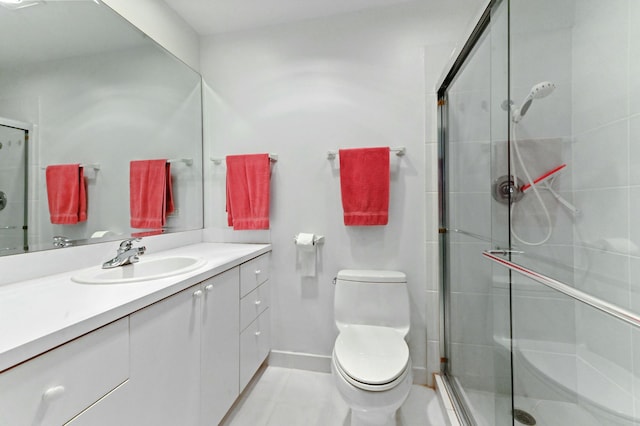 bathroom featuring vanity, toilet, and a shower with shower door