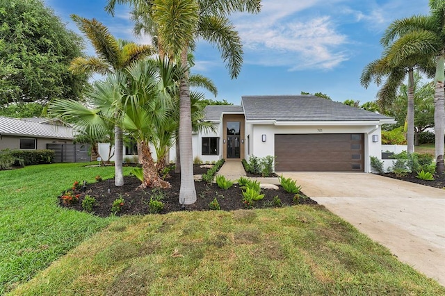 view of front of property with a front lawn and a garage