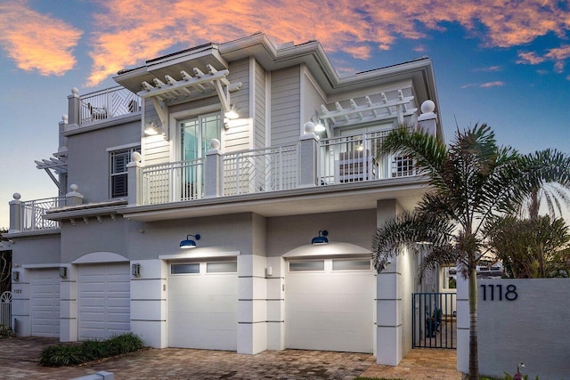 view of property featuring a garage and a balcony