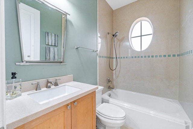 full bathroom with toilet, vanity, and tiled shower / bath