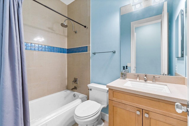 full bathroom with vanity, shower / bath combo, and toilet