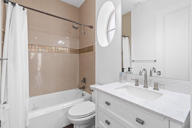 full bathroom featuring vanity, shower / tub combo, and toilet