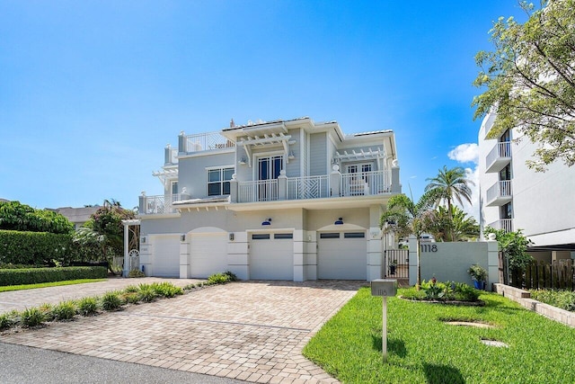 view of front facade featuring a balcony, a garage, fence, driveway, and a front lawn