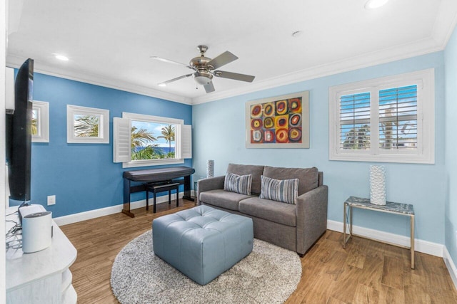 living room with wood-type flooring, ceiling fan, and crown molding