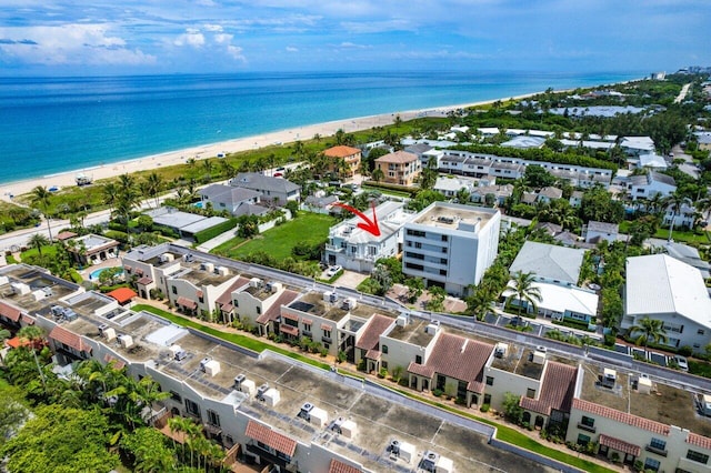 birds eye view of property featuring a water view and a beach view