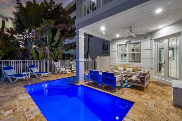 view of swimming pool featuring ceiling fan, a patio, and an outdoor hangout area