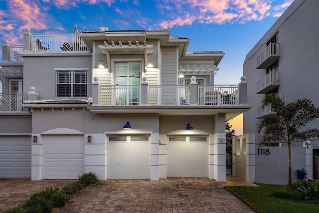 view of front facade featuring a balcony and a garage