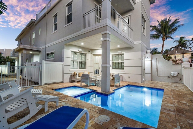 pool at dusk with a patio