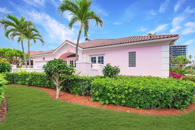 view of side of property with a yard